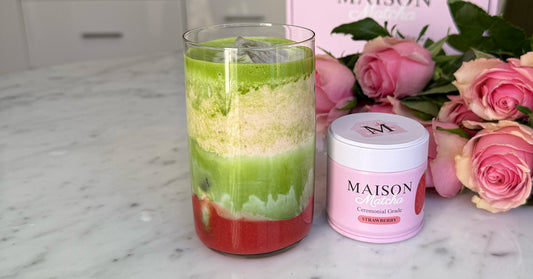 Iced strawberry matcha latte next to a can of Maison Matcha strawberry matcha