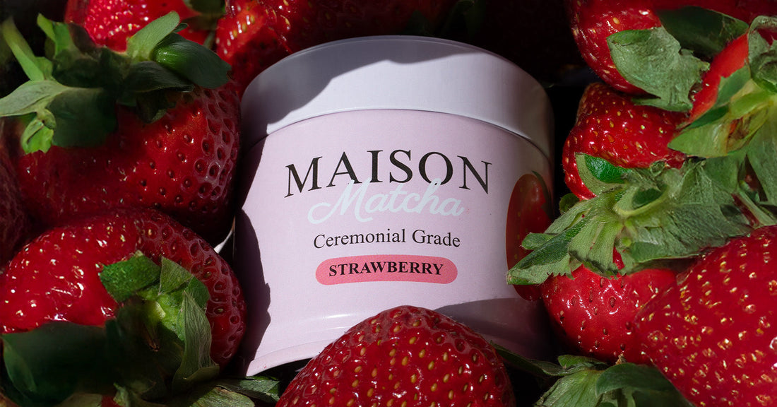 Maison Matcha's strawberry matcha powder can surrounded by fresh strawberries