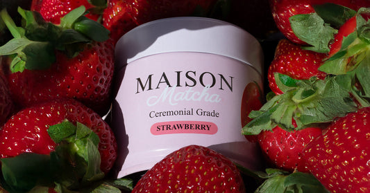 Maison Matcha's strawberry matcha powder can surrounded by fresh strawberries