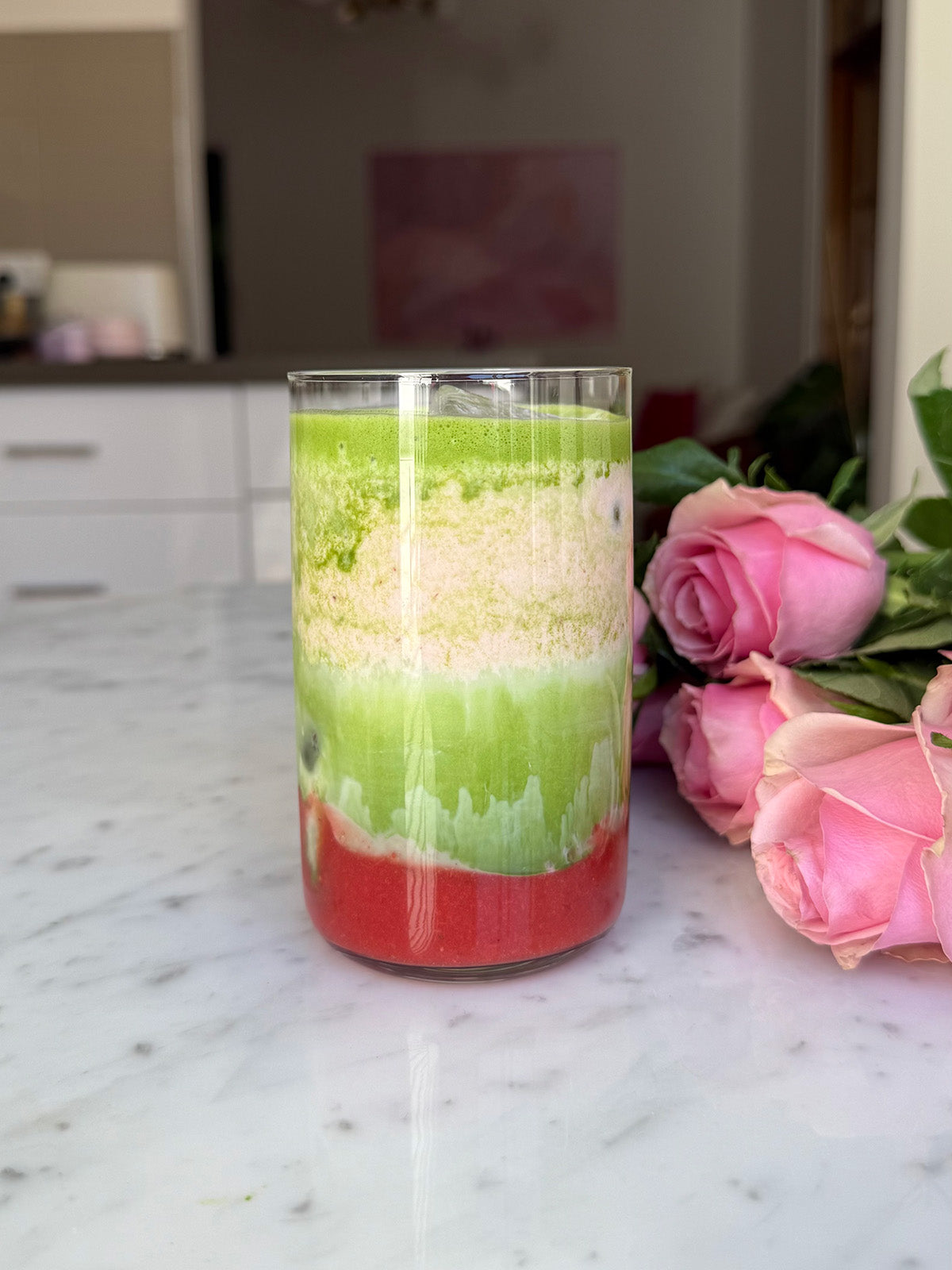 Iced strawberry matcha showing layers using maison matcha strawberry powder
