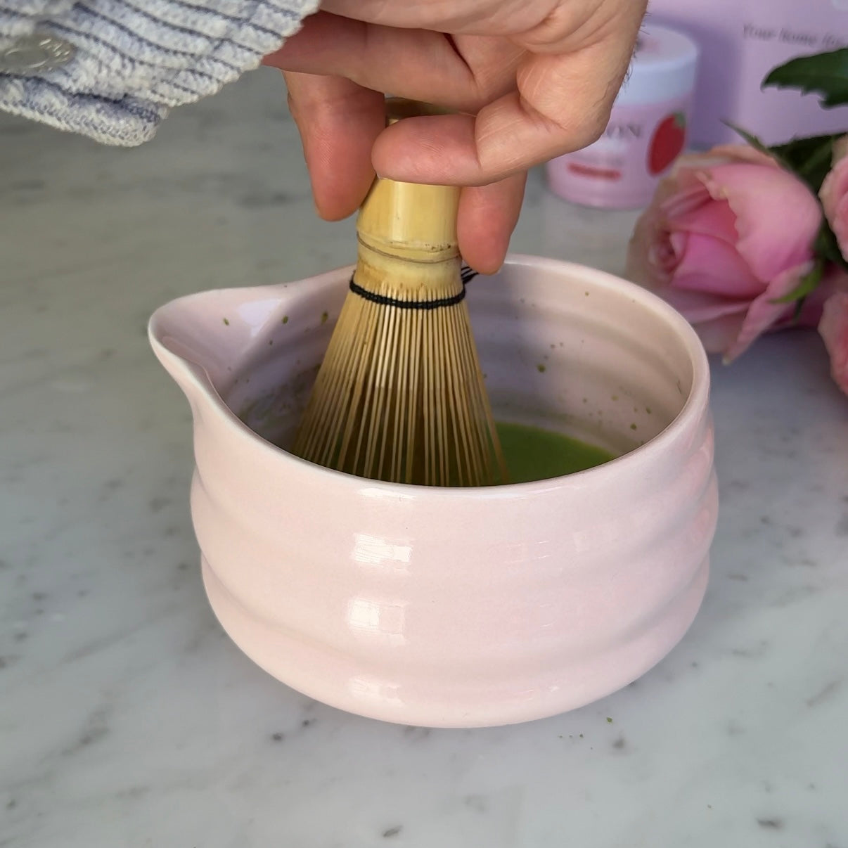 Maison Matcha's matcha powder being whisked in a pink bowl