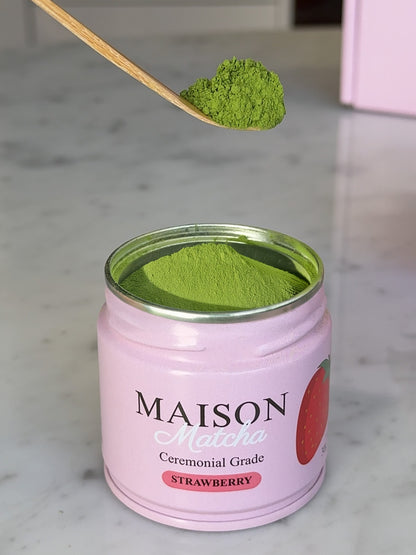 Maison Matcha's strawberry matcha powder being scooped out of pink can