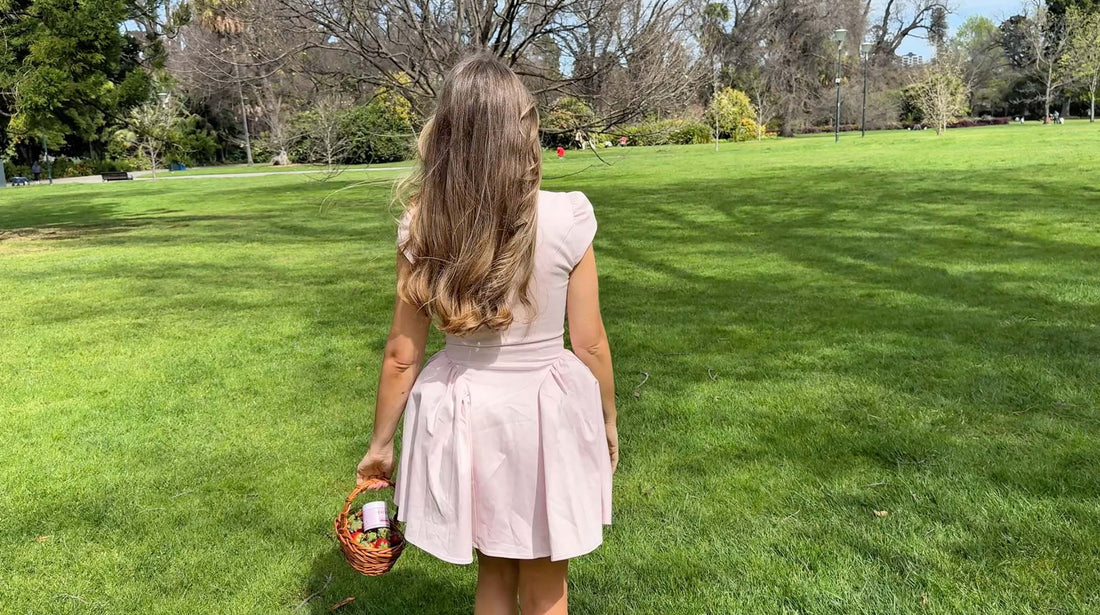 Cassandra Durand, founder of Maison Matcha, enjoying Maison Matcha in a sunny park, holding a cup of matcha while smiling. Lifestyle shot showcasing the brand’s premium matcha experience